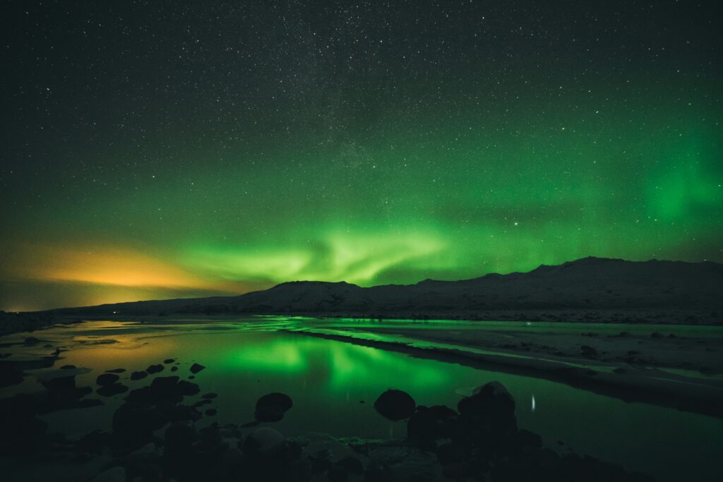 Aurora boreale riflessa sull’acqua in una zona remota dell’Islanda, nei dintorni di Þórsmörk